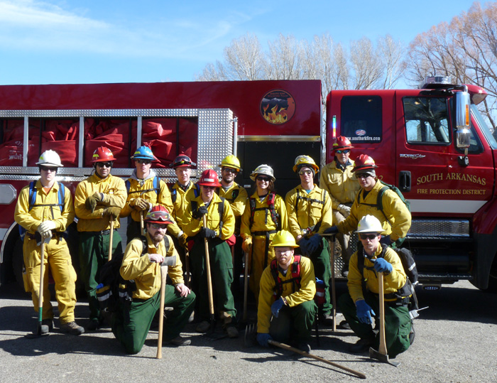 If you can't have a flag in the background, use a BRT: S-130/190 Basic Firefighter, #95 in March, 2012 stanging in front of Tender 12 (big red truck) from the South Arkansas Fire Protection District, supporting a live-fire exercise on the edge of Salida.